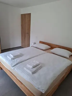 a large bed with white towels on top of it at Apartments Serafina in Tolmin