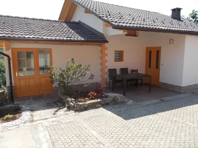 a patio of a house with a table in it at Apartma Prima in Podbočje