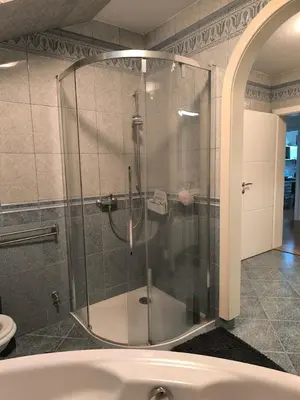 a bathroom with a shower with a glass door at Penthouse Villa Ljubljana in Šentvid
