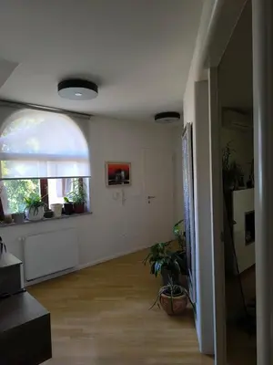 a living room with a hallway with a window and plants at Penthouse Villa Ljubljana in Šentvid