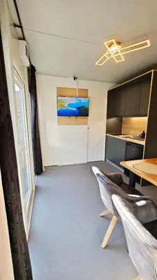 a room with a table and a dining room at Relax Tiny House Ljubljana in Ljubljana