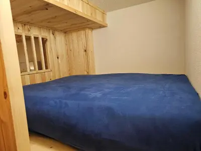 a bedroom with a blue bed in a room at Studio Masha's fairytale world in Kranjska Gora