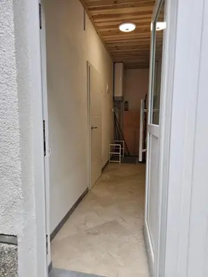 an empty hallway with a door open to a room at Studio Masha's fairytale world in Kranjska Gora