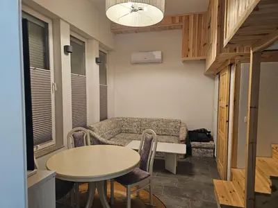 a living room with a table and a couch at Studio Masha's fairytale world in Kranjska Gora