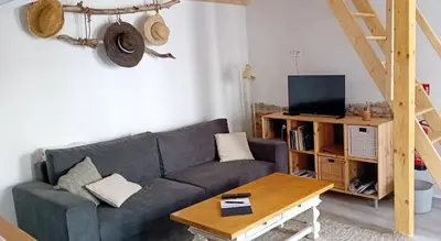 a living room with a blue couch and a table at Garage Apartments in Nova Gorica