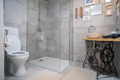 a bathroom with a shower and a toilet and a sink at Garage Apartments in Nova Gorica
