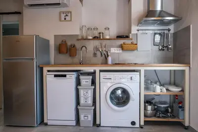 a kitchen with a dishwasher and a washer and dryer at Garage Apartments in Nova Gorica