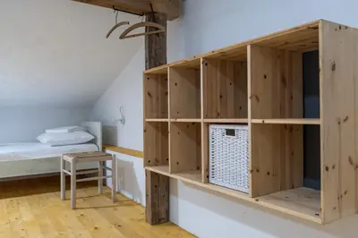 a room with wooden shelves and a bed at Garage Apartments in Nova Gorica
