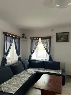 a living room with a blue couch and a table at Bohinj Countryside House in Bohinjska Bistrica