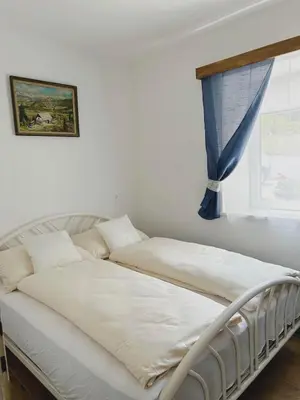 a white bed in a room with a window at Bohinj Countryside House in Bohinjska Bistrica