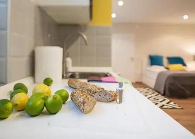 a pile of fruit and bread on a counter in a kitchen at Castle Rock Bled apartment in Bled