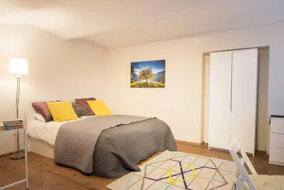 a bedroom with a bed and a painting on the wall at Castle Rock Bled apartment in Bled