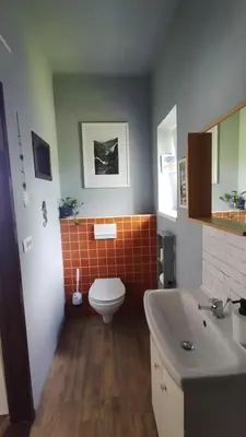 a bathroom with a toilet and a sink at Hiša Tarka in Dobrovnik