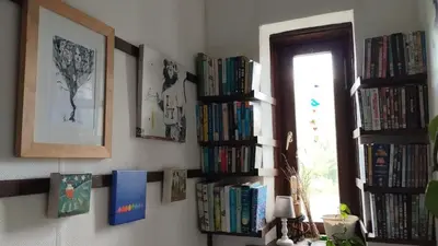 a room with several bookshelves filled with books at Hiša Tarka in Dobrovnik