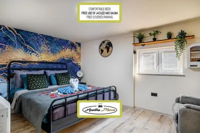a bedroom with a bed and a painting on the wall at Apartma Manca in Jesenice na Dolenjskem