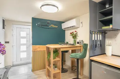 a small kitchen with a counter and a table at Apartma Manca in Jesenice na Dolenjskem