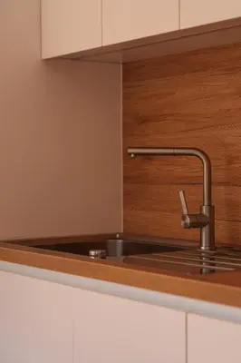 a kitchen sink with a faucet on top of it at Alpine Bliss Apartment Kranjska Gora in Kranjska Gora