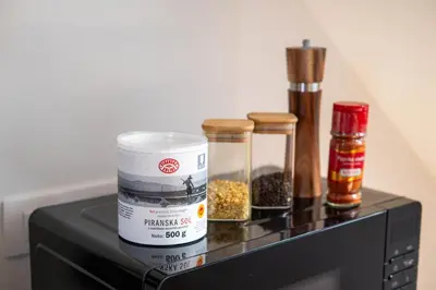 a counter with spices on top of a microwave at Apartment Berc in Bled