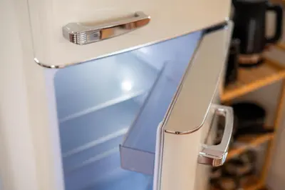 a refrigerator with its door open with a drawer at Apartment Berc in Bled