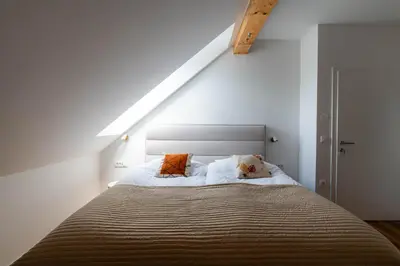 a bed with two pillows on it in a room at Apartment Berc in Bled