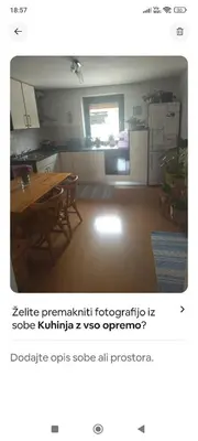 a kitchen with a table and a kitchen with a refrigerator at Lovely 1- bedroom apartment in Skofja Loka in Škofja Loka