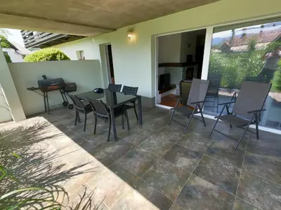 a patio with a table and chairs on it at GM apartma in Radovljica