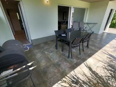 a dining room with a black table and chairs at GM apartma in Radovljica