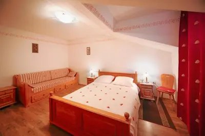 a bedroom with a bed and a couch at Green Escape garni hotel in Postojna