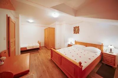 a bedroom with a large bed and a table at Green Escape garni hotel in Postojna
