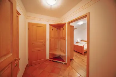 a room with a door and a bedroom with a bed at Green Escape garni hotel in Postojna