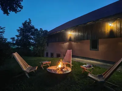 two chairs and a fire pit in a yard at Green Escape garni hotel in Postojna