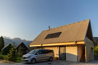 a van parked in front of a house at Chalet Bohinj Bliss Wellness and view of Triglav in Bohinj
