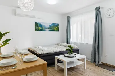 a living room with a couch and a table at Casa 1920 Apartment in Bovec