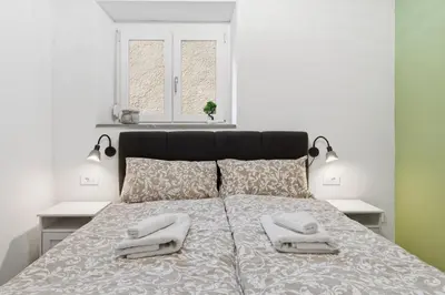 a bedroom with a bed with two towels on it at Casa 1920 Apartment in Bovec