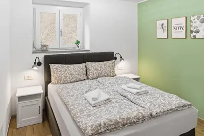 a bedroom with a bed with two towels on it at Casa 1920 Apartment in Bovec