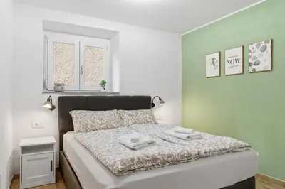 a bedroom with a bed with two towels on it at Casa 1920 Apartment in Bovec