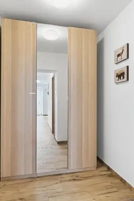 an empty room with wooden doors and a hallway at Casa 1920 Apartment in Bovec