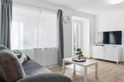 a living room with a couch and a table at Casa 1920 Apartment in Bovec