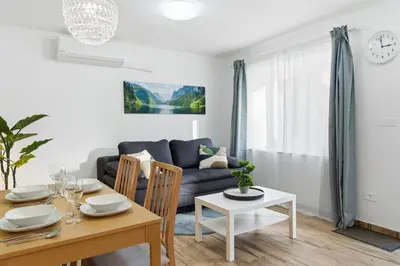 a living room with a table and a couch at Casa 1920 Apartment in Bovec