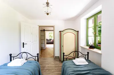 a bedroom with two beds and a mirror at Apartma FRIDA in Most na Soči