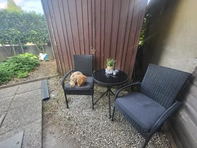 a cat sleeping on a table next to two chairs at Studio R in Ljubljana