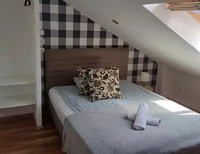 a bedroom with a bed with a pillow and a towel at Studio apartma ZARA in Slivnica pri Mariboru