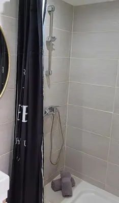 a shower with a black shower curtain in a bathroom at Studio apartma ZARA in Slivnica pri Mariboru