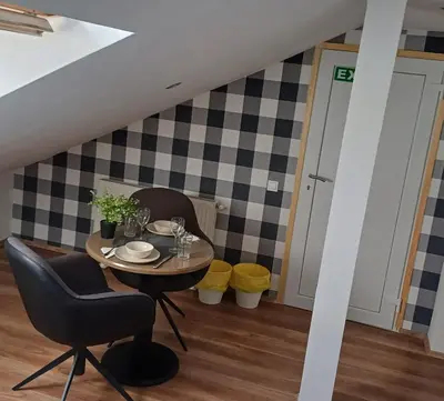 a dining room with a table and two chairs at Studio apartma ZARA in Slivnica pri Mariboru