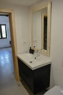 a bathroom with a sink and a mirror at Viktor Estate in Deskle