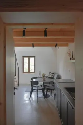 a kitchen and dining room with a table and chairs at Viktor Estate in Deskle