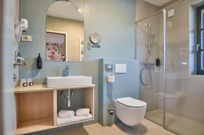 a bathroom with a toilet and a sink and a shower at Toplice Family Inn - Terme Čatež in Čatež ob Savi