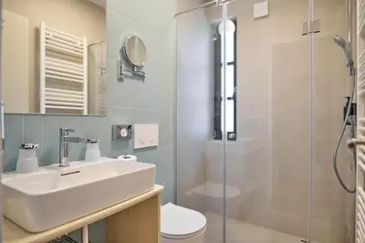 a bathroom with a sink and a shower at Toplice Family Inn - Terme Čatež in Čatež ob Savi