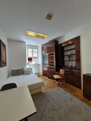 a bedroom with a bed and a table and a chair at Ritual Studio City Center in Ljubljana