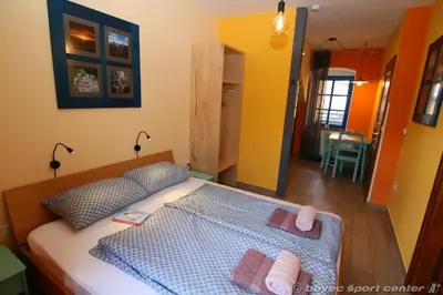 a bedroom with a bed with two towels on it at Apartments Bovec House Center in Bovec